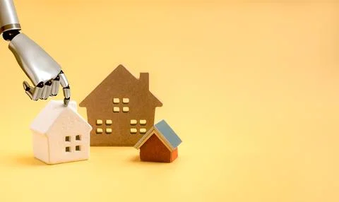 Robotic hand selects model house from multiple property options. AI-powered.. Stock Photos