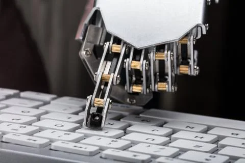 Robotic Hand Typing On Keyboard Stock Photos