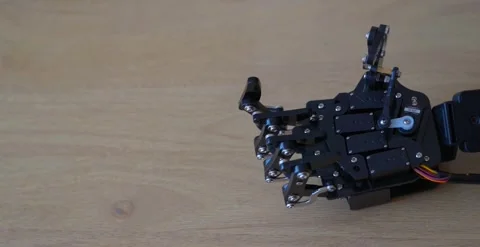 Robotic Hand On Wooden Table Stock Footage 248090157