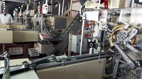 Robotic machine at a chocolate candy packaging factory Stock Footage 100980101