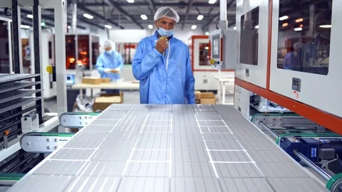Robotic manufacturing indoors. Worker controls the process of automated equipmen Stock Footage 119147396