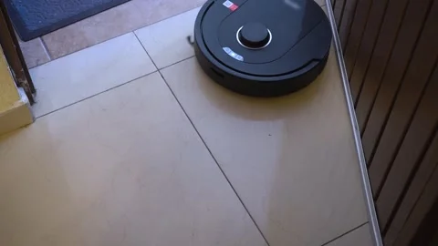 Robotic mop cleaning floors in entryway and hallway at home Stock Footage 327299489