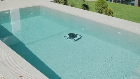 Robotic Pool Cleaner in Outdoor Pool Stock Footage 318748696