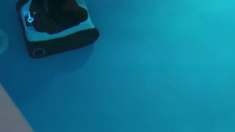 Robotic Pool Cleaner Vacuum Cleaning Swimming Pool at Night with Illuminate.. Stock Footage 346555661