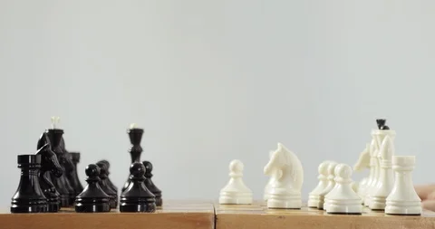 Robotic prosthetics hand is playing chess with human hand. Artificial Stock Footage 106221338