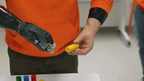Robotic Prosthetics pick up and move colored objects instead of hands. Close-up Video stock 263038226