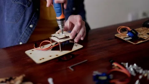 Robotic school project: Young student building robot vehicle Stock Footage 236566813