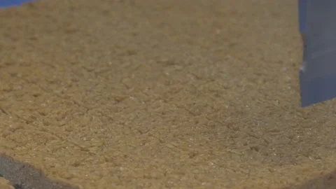 A robotic slicer cuts flapjack cake into bar shapes Stock Footage 132167030