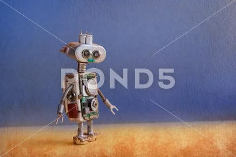Robotic ufo alien toy with lamp bulb eyes, metallic springs hands, blue yellow Stock Photos