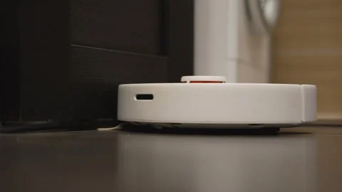 Robotic vacuum cleaner cleaning the floor Stock Footage 320867441