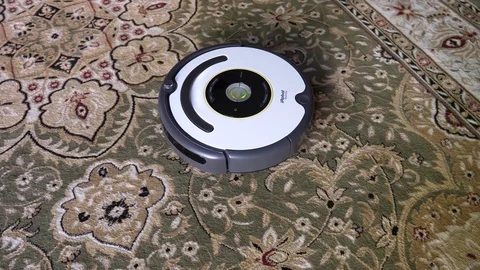 Robotic Vacuum Cleaner Irobot Roomba robot arrives to charging station home base Stock Footage 80504829