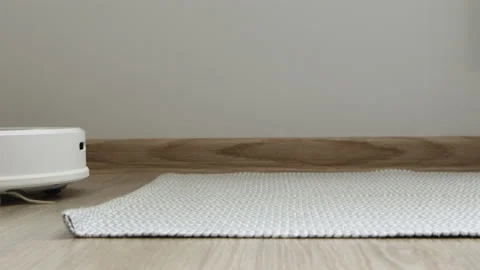 Robotic vacuum cleaner moving up on the carpet cleaning, close-up. Technology Vídeos de archivo 150887487