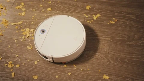Robotic vacuum cleaner riding around apartments Stock Footage 127459733