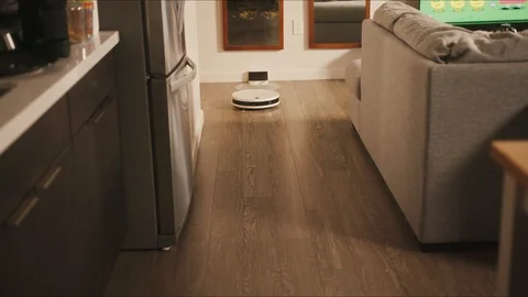 Robotic vacuum cleaner riding around apartments Stock Footage 127459756