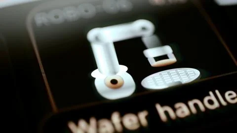 Robotic wafer handler beside patterned substrate Stock Photos