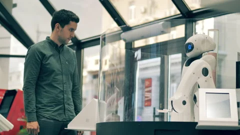 Robotic waiter taking order from a man. Futuristic robotic arm works serving man Video stock 140636062
