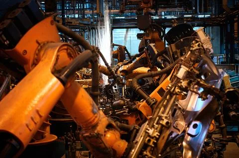 Robotic welder machine tools process metal details in shop Stock Photos