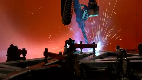 Robotic welding arm moving on orange background, real-time video 스톡 동영상 320940759