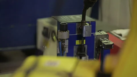Robotic welding machine in the factory. The robotic arm is preparing to work. Da Stock Footage 199486796