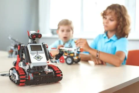Robotics. Children having class making machine concentrated blurred robot close Stock Photos