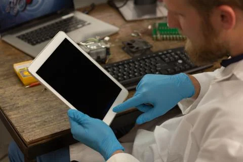 Robotics engineer using digital tablet at desk Stock Photos