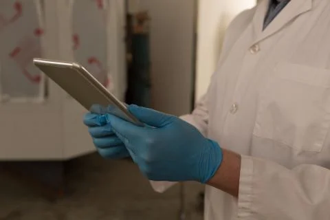 Robotics engineer using digital tablet in warehouse 스톡 사진