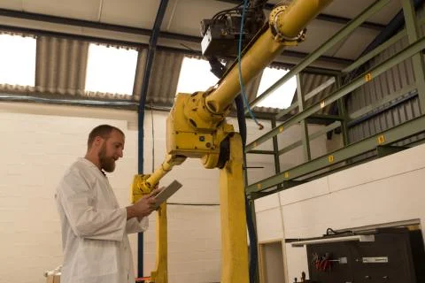 Robotics engineer using digital tablet Stock Photos