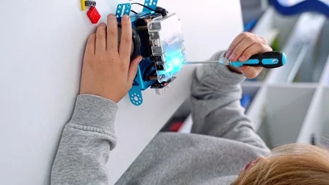 Robotics programming class. Child construct Mbot screwdriver and code Robot Stock Footage 246124907