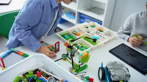 Robotics programming class. Children construct and code Robot. STEM education Stock Footage 238699154