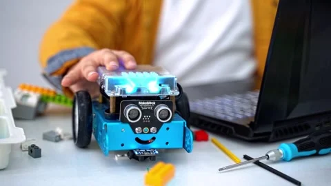Robotics programming class. Children construct Mbot and code Robot. STEM Stock Footage 252935469