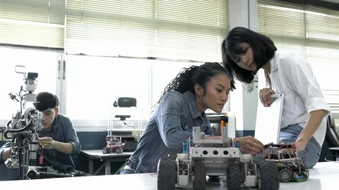Robotics team collaborating development robot in modern laboratory. Stock Footage 113001182