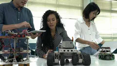 Robotics team collaborating development robot in modern laboratory. Stock Footage 113002582