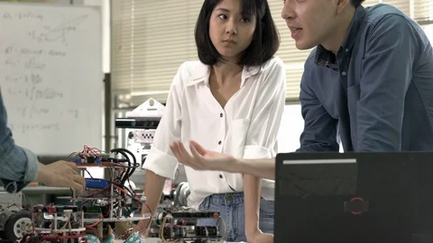 Robotics team collaborating development robot in modern laboratory. Stock Footage 113704024