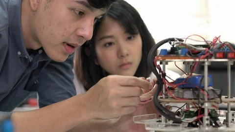 Robotics team collaborating development robot in modern laboratory. Stock Footage 113705622