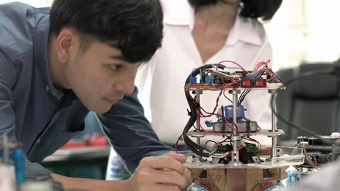 Robotics team collaborating development robot in modern laboratory. Stock Footage 113705738