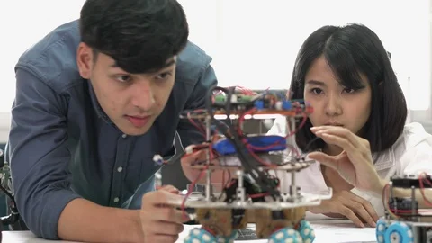 Robotics team collaborating development robot in modern laboratory. Stock Footage 113705978