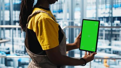 Robotics technician using chroma key device in smart factory 写真素材