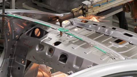 Robots collect and weld car bodies at the car factory Stock Footage 92197744