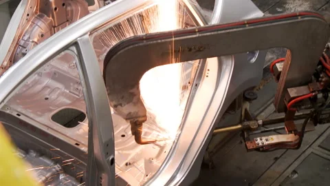 Robots collect and weld car bodies at the car factory Stock Footage 92197767