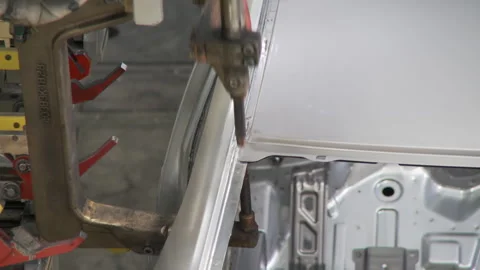 Robots collect and weld car bodies at the car factory Stock Footage 92197778