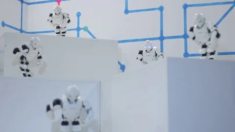 Robots dancing on a white stage Stock Footage 81786871