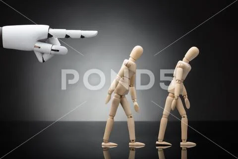 Robot's Hand Giving Direction To Two Wooden Dummies Stock Photos
