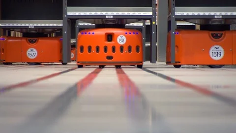 Robots moving in a storage capacity Stock Footage 99052112