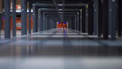 Robots moving in a storage capacity Stock Footage 99052181
