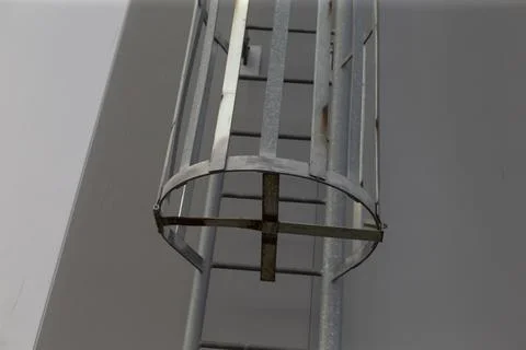 Robust metal framework surrounds ladder opening emphasizing symmetry Stock Photos