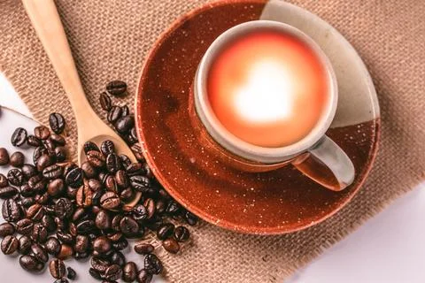 Robusta coffee beans and brown ceramic coffee cups Stock Photos
