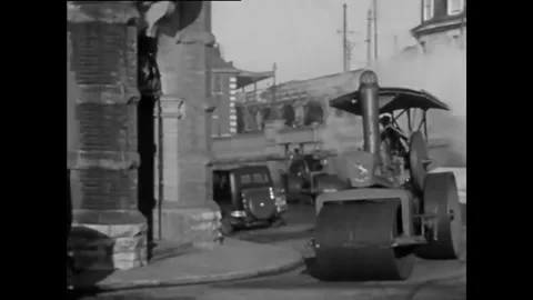 ROCHESTER - 1929 - Men driving steamrollers on the street. Two men enter a Stock Footage 340589356