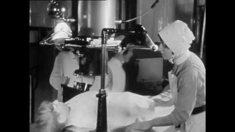 ROCHESTER - 1929 - Nurses use an x-ray machine on an injured patient. Surgeons Stock Footage 340589293