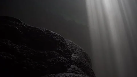 Rock And Sunrays Streaming Through Goa Jomblang Stockbeeldmateriaal 146103901