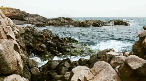 Rock and waves on shore or coast of ocean or sea Stock Footage 49672903
